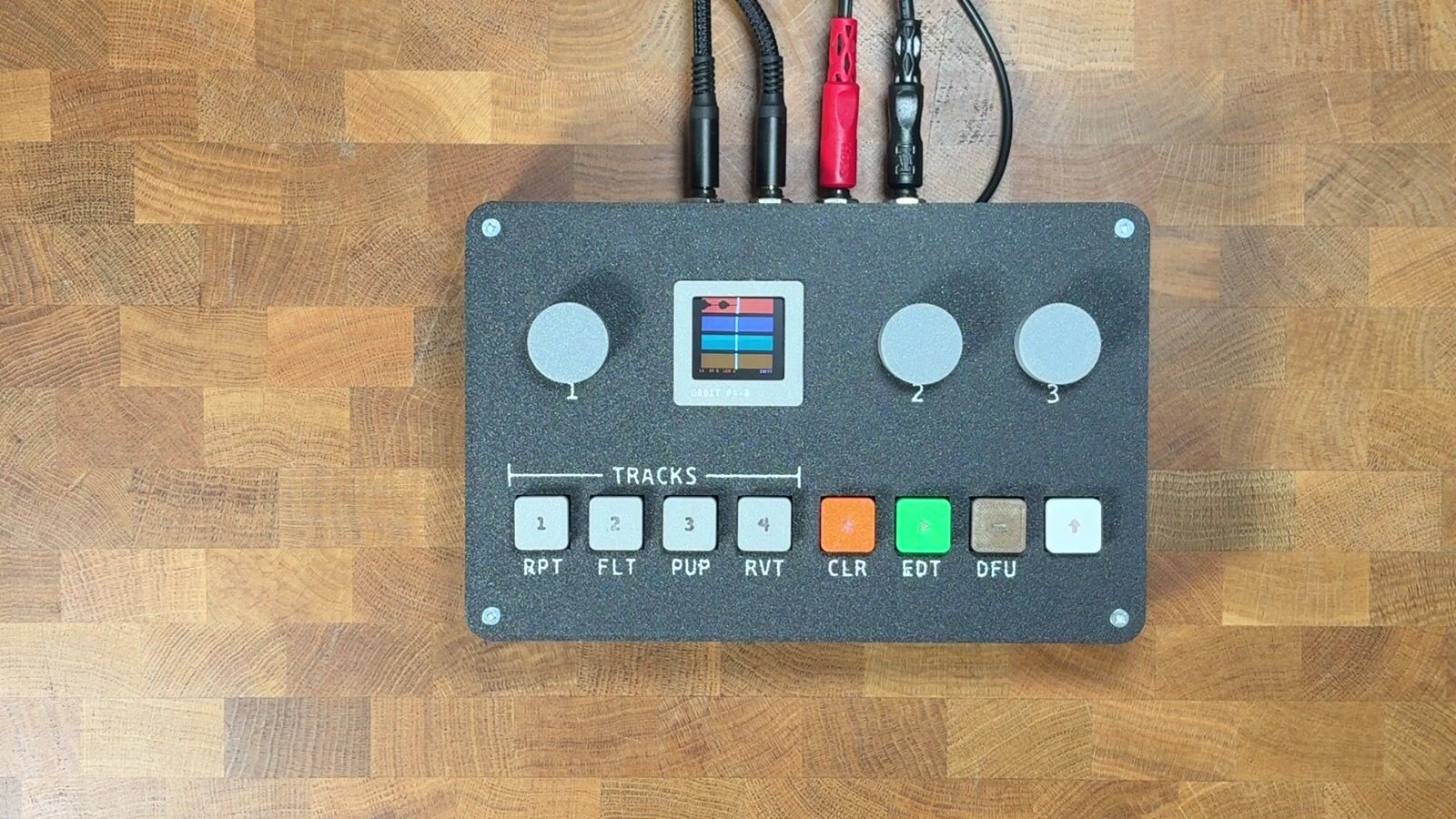 ORBIT PX-8, a four-track hardware looper, on a wooden desk with cables connected